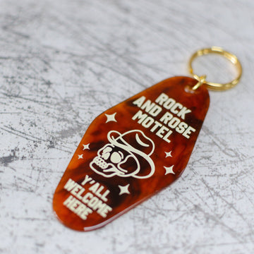 Rock And Rose Motel Keychain In A Motel Key Style Close Up View